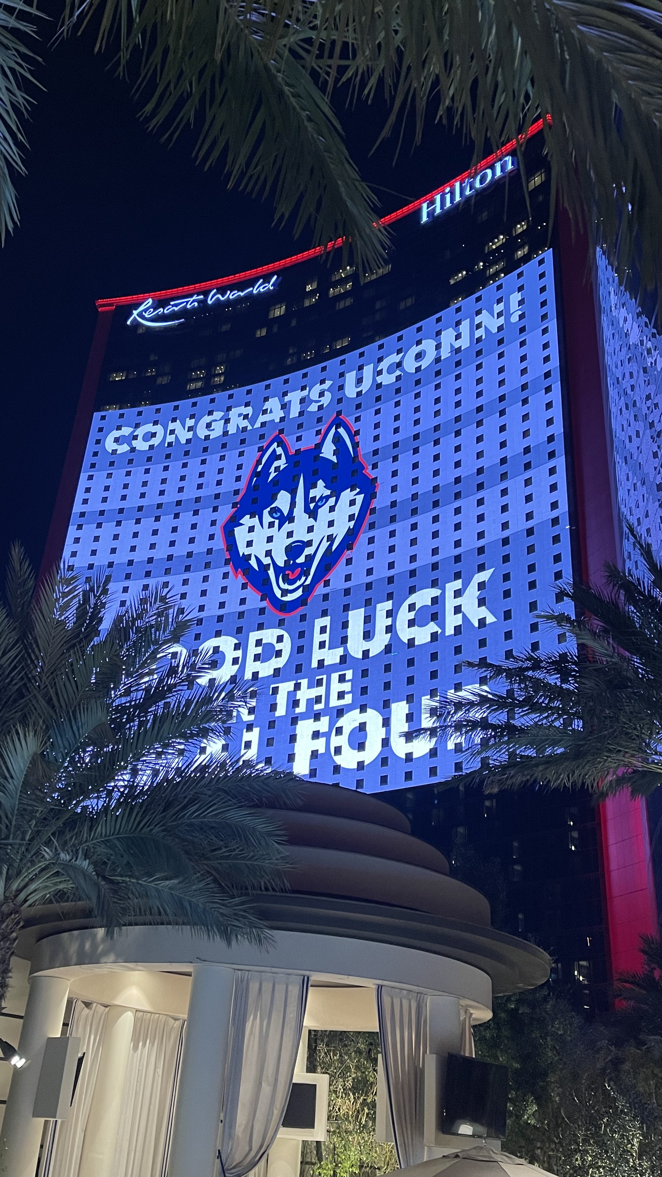 Resorts World Las Vegas lit up with a UConn Husky logo reading Congrats UConn, Good Luck to the Final Four
